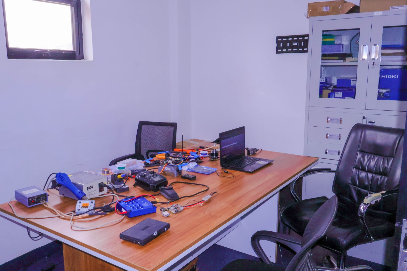 DAIL Mechanical and Airframe Fabrication Laboratory showing composite carbon fiber frames, motor dynamometer test rig, chassis components and assembly jigs.